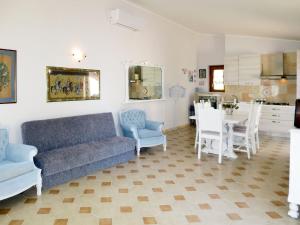 a living room with a couch and a table and chairs at Apartment Amalasunta by Interhome in Marta
