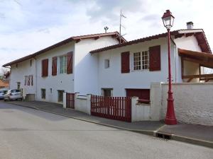 a red street light in front of a white house at Apartment Kafartenea by Interhome in Urrugne