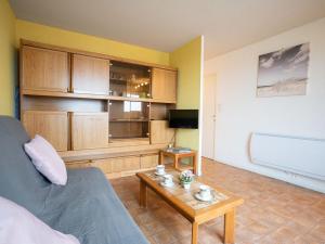 a living room with a couch and a coffee table at Apartment Les Sables d'Or-5 by Interhome in Le Grau-du-Roi