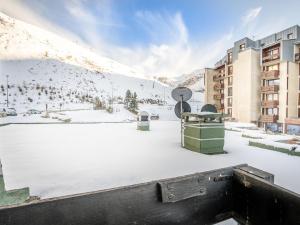 a snow covered rooftop of a building with a snow covered mountain at Apartment Le Grand Tichot A et B - Val Claret-3 by Interhome in Tignes