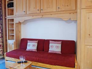 salon z czerwoną kanapą i stołem w obiekcie Apartment Le Grand Tichot A et B-8 by Interhome w mieście Tignes