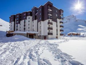 a building in the snow with a pile of snow at Apartment Les Tommeuses - Val Claret-2 by Interhome in Tignes