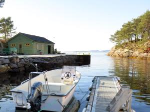 Un barco está atracado en un muelle en el agua. en Holiday Home Solsvika by Interhome, en Leirvik