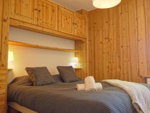 a bedroom with a large bed with wooden walls at Apartment Le Curling A - Val Claret-13 by Interhome in Tignes