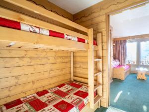 a bedroom with two bunk beds and a window at Apartment Neves-1 by Interhome in Val Thorens