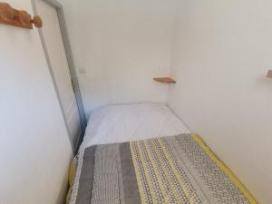a small bedroom with a bed in a room at Boost Your Immo Gardette Réallon A11 in Réallon