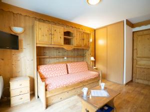 a living room with a couch and a table at Apartment Balcons D'Olympie-5 by Interhome in Les Menuires