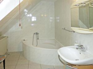 Baño blanco con bañera y lavamanos en Holiday Home Racz - BAC114 by Interhome, en Badacsonytomaj
