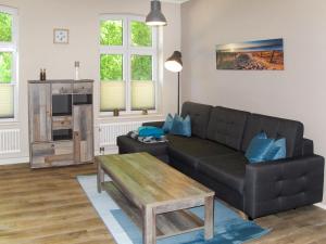 a living room with a couch and a coffee table at Apartment Helene by Interhome in Ribnitz-Damgarten