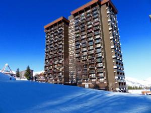 a large building on top of a snow covered slope at Apartment Vostok Zodiaque-61 by Interhome in Le Corbier