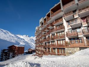 a building in the snow with a mountain in the background at Apartment Le Curling B-9 by Interhome in Tignes