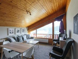 a living room with a couch and a table at Apartment Le Hameau-7 by Interhome in Les Collons