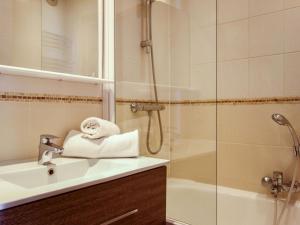a bathroom with a sink and a shower at Apartment La Divaria by Interhome in Tignes