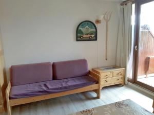 a couch in a living room with a table at Apartment Les Balcons de L'Etale by Interhome in La Charmette