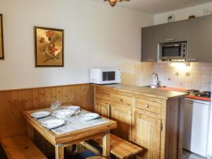 a kitchen with a table with plates on it at Apartment La Divaria-6 in Tignes