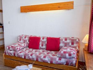 a living room with a couch with red and white pillows at Apartment Les Moutières B1 et B2 - Val Claret-20 by Interhome in Tignes