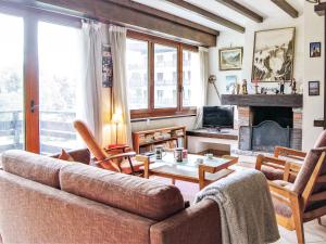 a living room with a couch and a fireplace at Apartment Le Bois du Bouchet-1 by Interhome in Chamonix +15 photos