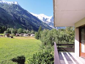 a balcony of a house with a view of mountains at Apartment Le Bois du Bouchet-1 by Interhome in Chamonix