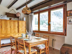 a dining room with a wooden table and chairs at Apartment Le Bois du Bouchet-1 by Interhome in Chamonix