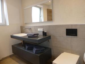 a bathroom with a sink and a mirror at Apartment Stefanie by Interhome in Taxenbach