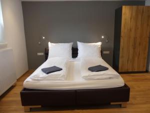 a bed with two pillows on it in a room at Apartment Stefanie by Interhome in Taxenbach