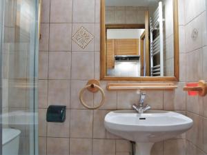 a bathroom with a sink and a mirror at Apartment Le Choucas by Interhome in Chamonix