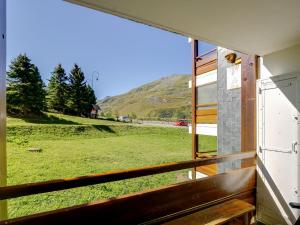 a window with a view of a field of grass at Apartment Burons R05 by Interhome in Les Menuires