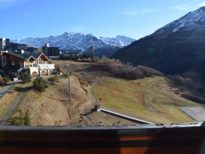 a house on a hill with mountains in the background at Apartment Belleville Caron-5 by Interhome in Les Menuires