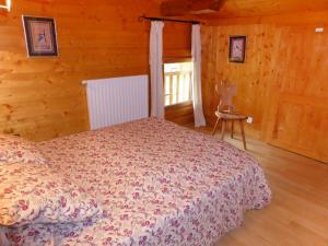 a bedroom with a bed in a wooden cabin at Apartment Les Moranches by Interhome in Les Contamines-Montjoie