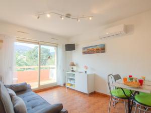 a living room with a couch and a table at Apartment La Croix du Sud-4 by Interhome in Cavalaire-sur-Mer