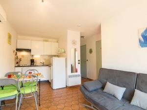 a living room with a couch and a kitchen at Apartment La Croix du Sud-4 by Interhome in Cavalaire-sur-Mer