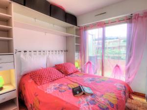 a bedroom with a bed and a window at Apartment La Croix du Sud-4 by Interhome in Cavalaire-sur-Mer