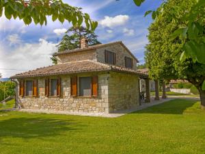 an old stone house in a field of grass at Holiday Home Sunflower by Interhome in Acqualoreto