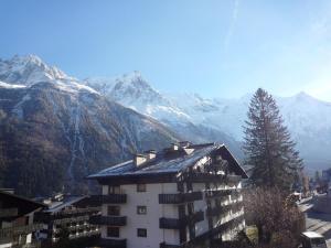 a building in front of a mountain with snow at Apartment Les Aiguilles du Brévent by Interhome in Chamonix-Mont-Blanc