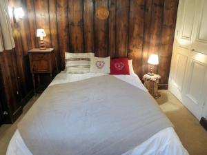 a bedroom with a large bed with wooden walls at Apartment Le Brévent-14 by Interhome in Chamonix-Mont-Blanc