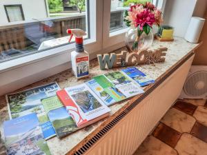a window sill with books and a bottle of wine at Holiday Home Stefanie by Interhome in Mühldorf