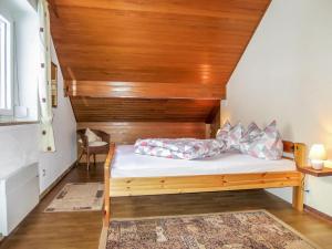 a bedroom with a bed with a wooden headboard at Holiday Home Stefanie by Interhome in Mühldorf