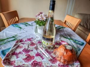 a bottle of wine sitting on top of a table at Holiday Home Stefanie by Interhome in Mühldorf