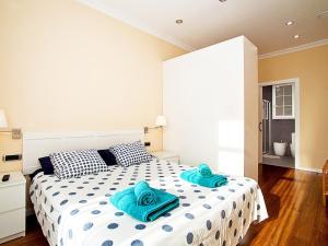 a bedroom with a large bed with blue towels on it at Apartment Eixample Esquerre Gran Via Balmes by Interhome in Barcelona
