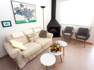 a living room with a couch and a fireplace at Holiday Home El Palmar Playa Romana by Interhome in Alcossebre