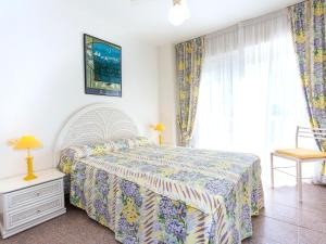 a bedroom with a large bed and a window at Holiday Home El Palmar Playa Romana by Interhome in Alcossebre