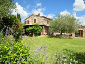 a large stone house with a garden in front of it at Holiday Home Val d'Orcia by Interhome in Radicofani