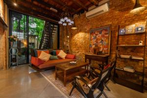 a living room with a couch and a table at Spices Hotel in George Town