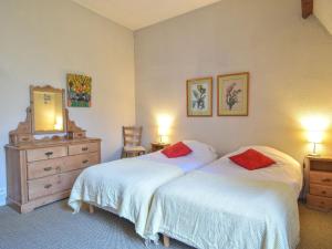 a bedroom with two beds and a dresser and a mirror at Apartment Les Flots-2 by Interhome in Trouville-sur-Mer