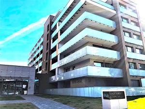 a tall building with a sign in front of it at Apartament Superior Lawendowy z Tarasem in Kołobrzeg