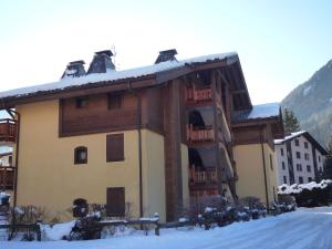 a large building with snow on the roof at Apartment Les Capucins by Interhome in Chamonix