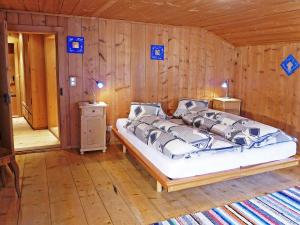 a bedroom with a bed in a wooden room at Holiday Home Ferienhaus Döss by Interhome in Müstair