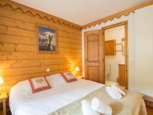 a bedroom with a white bed with wooden walls at Apartment Ecrin des Neiges - Val Claret-1 by Interhome in Tignes
