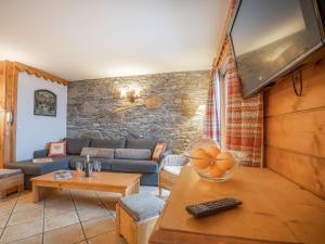 a living room with a couch and a tv at Apartment Ecrin des Neiges - Val Claret-1 by Interhome in Tignes