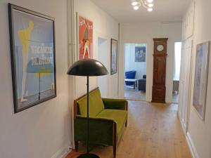 a living room with a green chair and a lamp at Apartment Haus Altein Apartment Nr- 4 by Interhome in Davos
